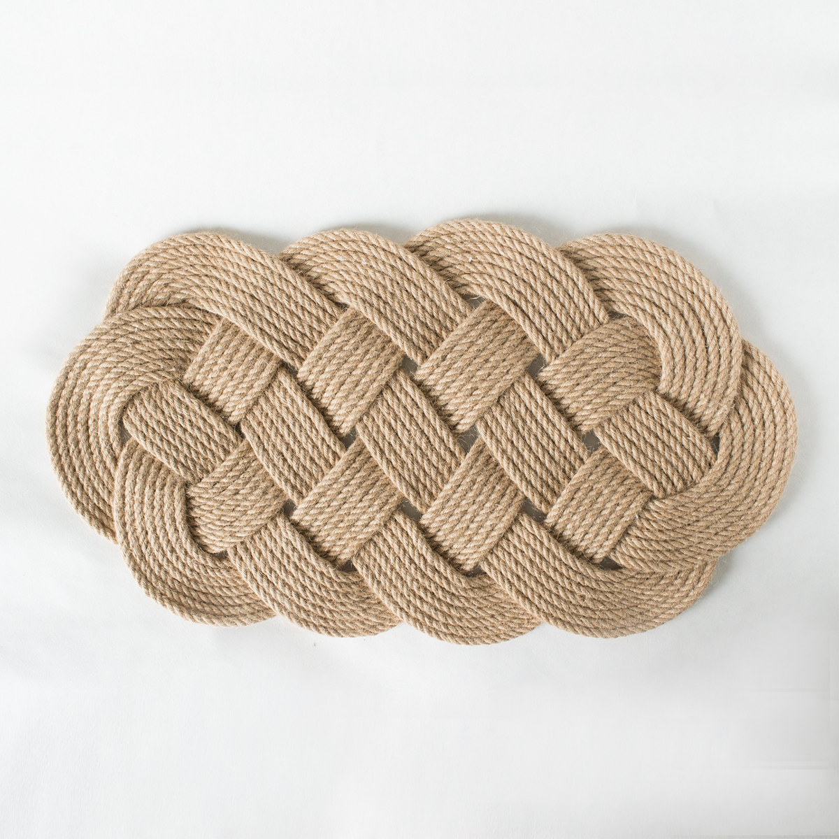 Natural rope woven doormat with a braided knot design on a white background
